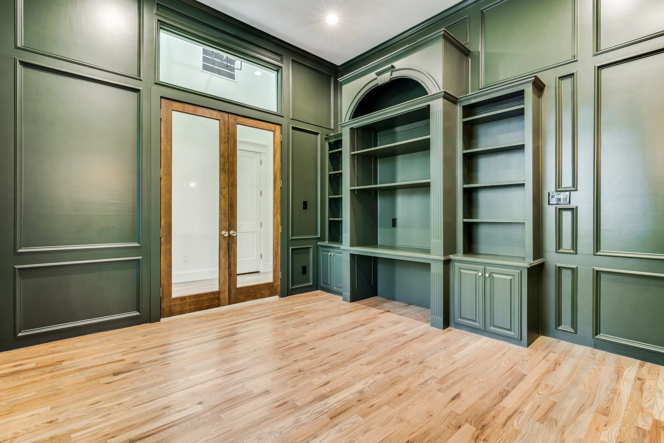 Custom green millwork and built-in shelving in a Royse City home